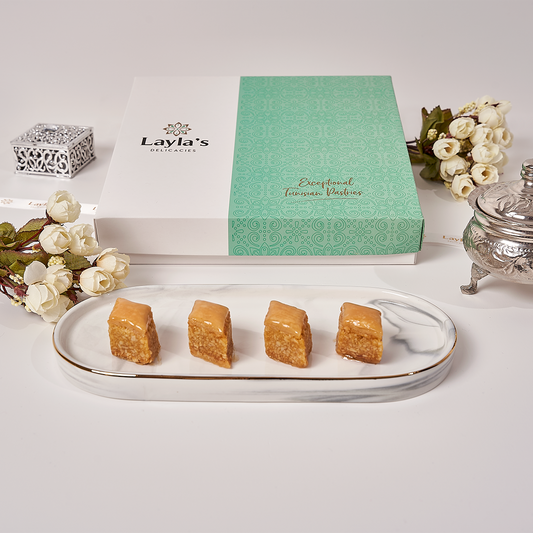 Front view of an 18-piece almond baklava gift box with individually wrapped Mediterranean pastries