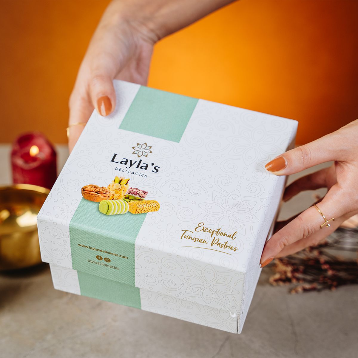 Person holding Layla's Delicacies 23 pieces Appreciation gift box in a gifting way