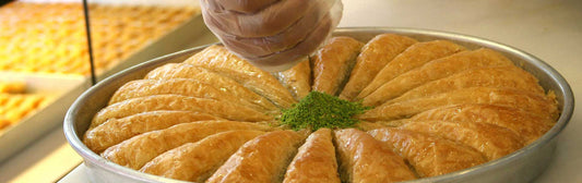Person preparing sweet baklava
