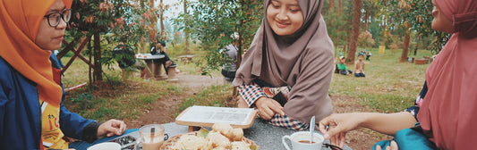 Woman sitting in front of table