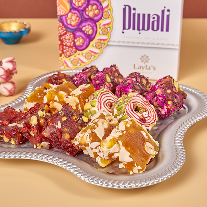 Close-up of vegan Lokum pieces from Diwali Lokum Special box, highlighting texture and colors of the pieces inside such as Orange Hazelnut, Pomegranate Pistachio, Rose Pomegranate Pistachio, Sesame Hazelnut, and Pistachio