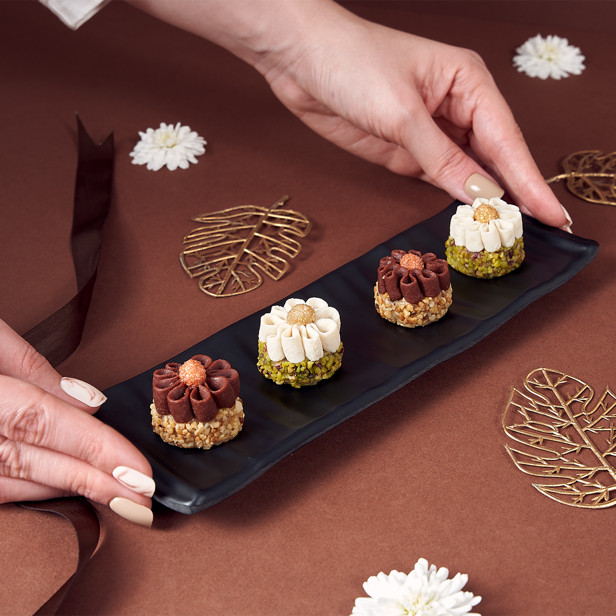 Close-up of flower-shaped pistachio and hazelnut sweets from Flora box