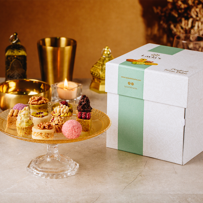 Layla's Delicacies 46 pieces Appreciation gift box presented on a counter next to the handmade sweets on a plate