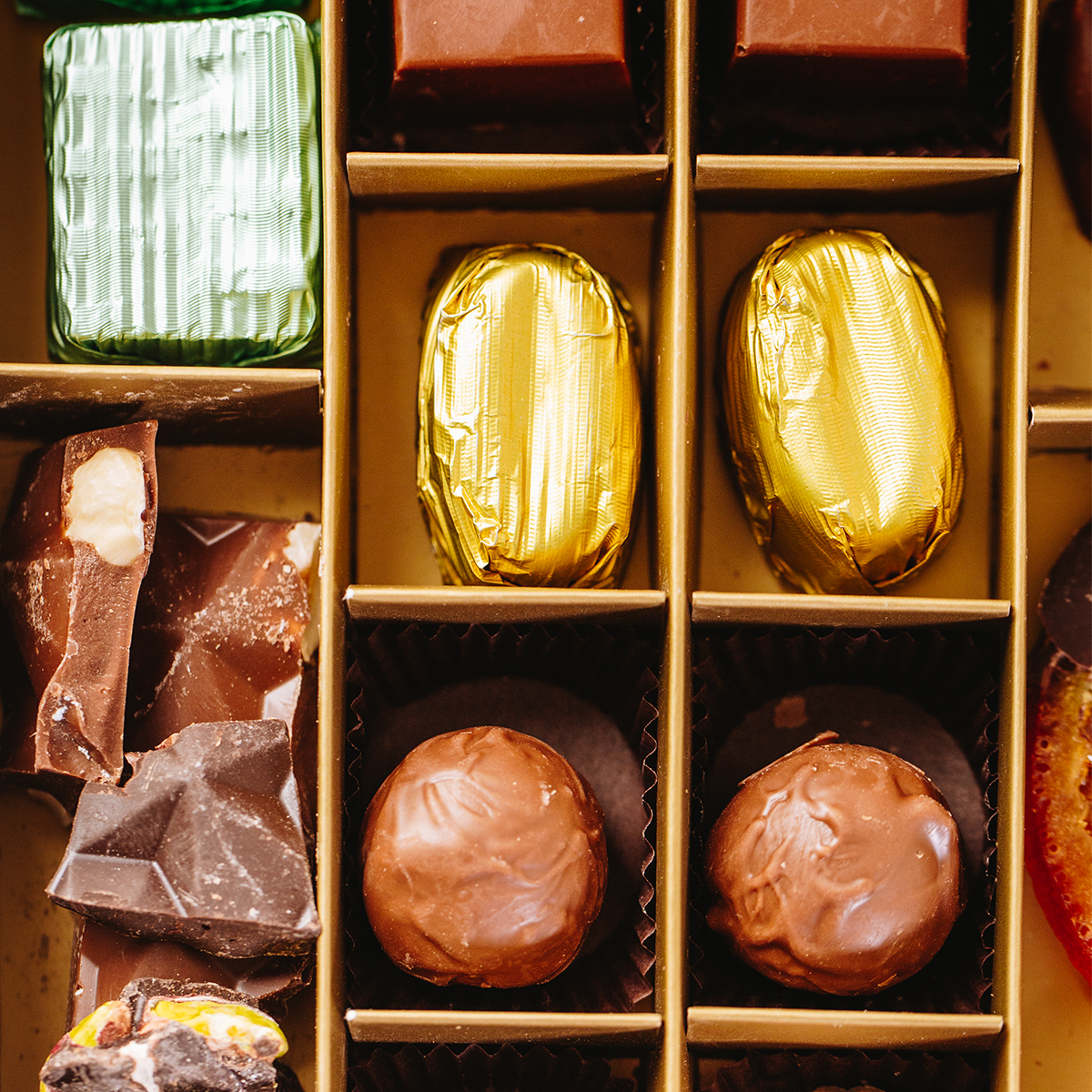 Assorted chocolates of the Layla's Delicacies valentine's gift box including gold-wrapped Coffee Filling – Milky Bean and hazelnut cream milky truffle