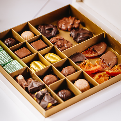 Assorted chocolates in Layla's Delicacies' valentines gift box on a white surface