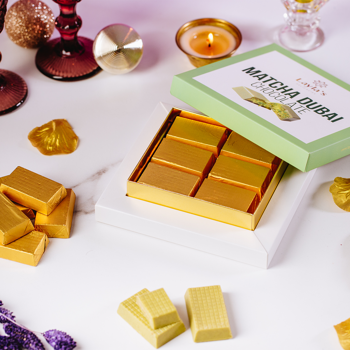 Gold Matcha Dubai chocolate bars in a box with a green label on a white surface.