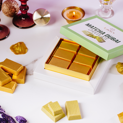 Gold Matcha Dubai chocolate bars in a box with a green label on a white surface.